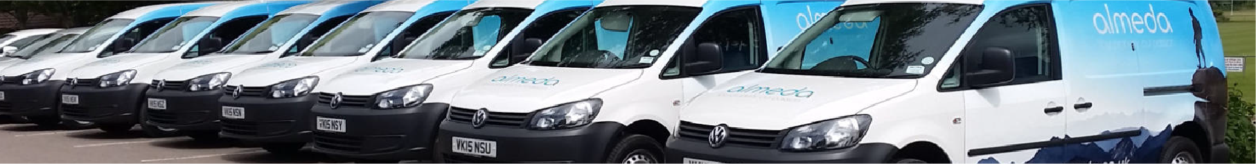 Fleet of white vans with the same van sign writing design