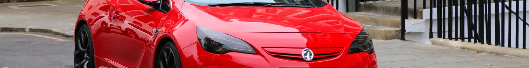 Vauxhall window tint on a red Vauxhall parked on the road