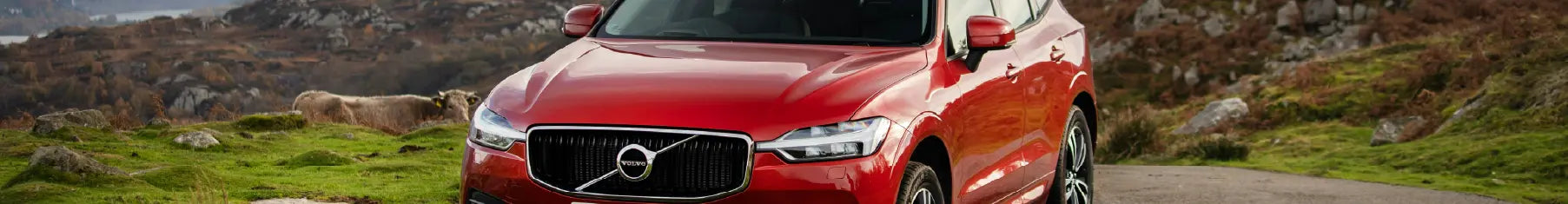 Volvo window tint installed to a red Volvo with rugged landscape in the background