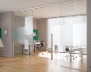 White frosted film applied as a central privacy band across a meeting-room glass partition, with clear glass above and below.