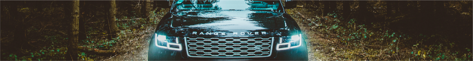 Cropped photo of a Land Rover on the road after professional Land Rover window tint installation