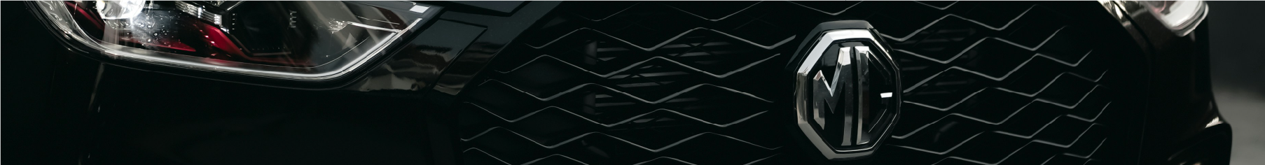 Close-up of an MG car on the road after new MG window tints installation