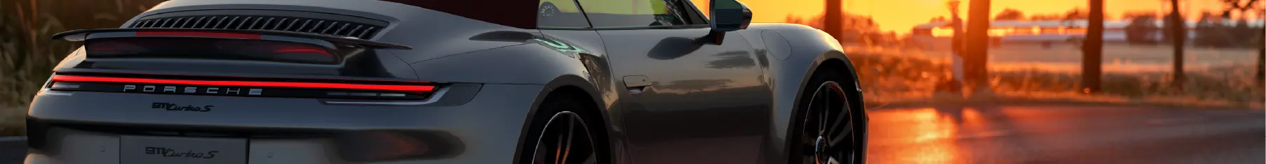 Porsche with new Porsche window tints installed with a sunset background