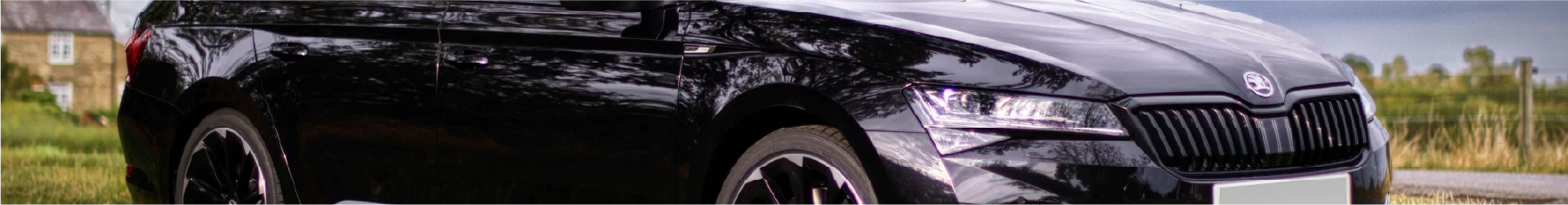 Black Skoda with new Skoda window tints installed parked on a field