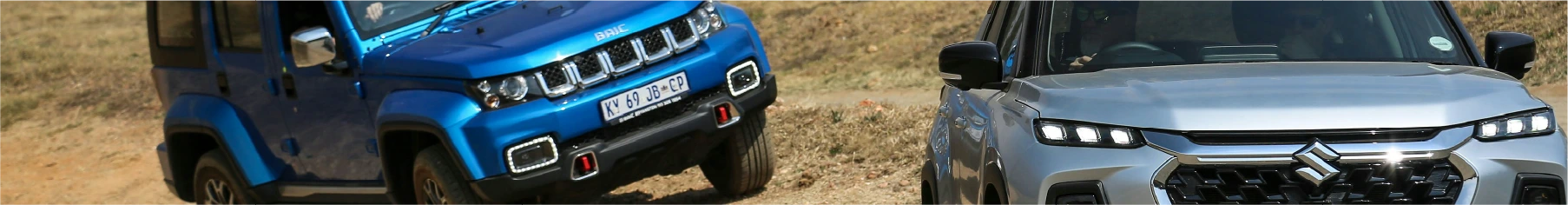 Two Suzukis on rugged terrain, both with Suzuki window tint installed