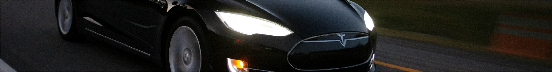 Black Tesla with Tesla window tint installed driving on a motorway