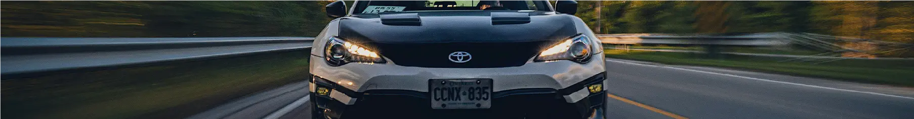 Toyota window tint on a white Toyota with a black bonnet on a motorway